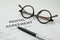 Pen and eyeglasses on rental agreement printed document, ready t