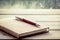 Pen on notebook on wooden table in rainy day window background