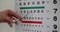 Pen pointing to letter on vision test chart