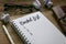 Pen,trash paper,sunglasses, and notebook written with Bucket List on wooden background