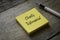 Pen and yellow sticky notes written with Clients Testimonial on wooden background