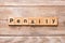 PENALTY word written on wood block. PENALTY text on wooden table for your desing, concept