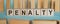 PENALTY Word Written In Wooden Cubes on blue background