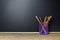 Pencil in basket on wood table with Blackboard Chalk Board