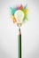 Pencil close-up with colored paint splashes and lightbulb concept