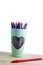 Pencil color group in green cup on the wooden table