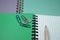 Pencil crayon and paperclips on open notebook