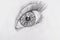 Pencil drawing of a female eye on white paper