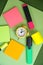 Pencil markers in intense fluorescent colors, post it a small yellow clock in the middle