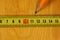 Pencil marking of a wooden cutting board with a metal measuring tape