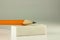 Pencil resting on a white eraser