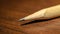 Pencil on top of wooden table abstract , Pencil on wooden table shallow depth , Pencil and bokeh