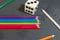 Pencils with dice and domino on a grey background.Flag of the Italian peace organization PACE