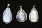 Pendants made of rainbow moonstone behind a black surface