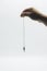 Pendulum dowsing on an isolated white background with a silver point