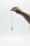 Pendulum dowsing on an isolated white background with a silver point