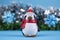 Penguin doll with Christmas decorations on blue background