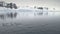 Penguins jumping in Antarctica ocean. Aerial shot.