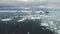 Penguins jumping in Antarctica ocean. Aerial shot.