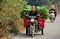 Pengzhou, China: Farmer Driving Motorcycle Cart along Country Road