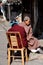 Pengzhou, China: Monk & Woman Sitting in Front of Home