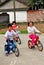 Pengzhou, China: Three Chinese Children Riding Bicycles