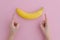 Penis Size Concept. Woman jokingly measures size of a banana