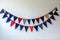 pennant bunting strung against a plain wall