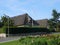 Pennant flying over Whitewashed thatched house