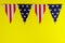 Pennants of stars and stripes flags yellow background american holiday