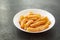 Penne Amatriciana fresh pasta with parmesan cheese on dark background