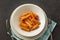 Penne Amatriciana fresh pasta with parmesan cheese on dark background