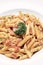 Penne amatriciana tomato and ham sauce pasta on white table