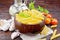 Penne in bowl of coconut with vegetables on wooden board