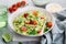 Penne pasta with creamy avocado sauce and tomatoes