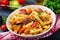 Penne pasta with meatballs in tomato sauce