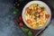 Penne pasta with meatballs tomatoes and sauce on a dark background, top view