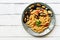 Penne pasta with mussels on a white wooden rustic table. Top view, copy space.