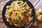 Penne Pasta with pesto, chicken breast and lemon closeup. Horizontal top view