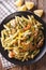 Penne Pasta with pesto, chicken breast and lemon closeup. Vertical top view