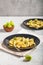 Penne pasta with romanesco cabbage on light gray background