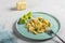 Penne pasta with romanesco cabbage on light gray background