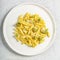 Penne pasta with romanesco cabbage on light gray background