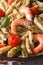 Penne pasta with shrimp, tomato and pesto macro. Vertical