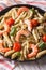 Penne pasta with shrimp, tomato and pesto on a plate closeup. ve