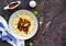 Penne pasta with tomato sauce, carrots and black beans in a gray bowl on a dark concrete background. Lenten dishes. Bean Recipes.