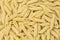 Pennette rigate. Background of raw pasta