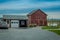 Pennsylvania, USA, APRIL, 18, 2018: Outdoor view of parked Amish buggy carriage in a garage close to a modern car