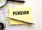 PENSION text on a sticker on your desktop. Pen and magnifier