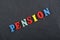 PENSION word on black board background composed from colorful abc alphabet block wooden letters, copy space for ad text
